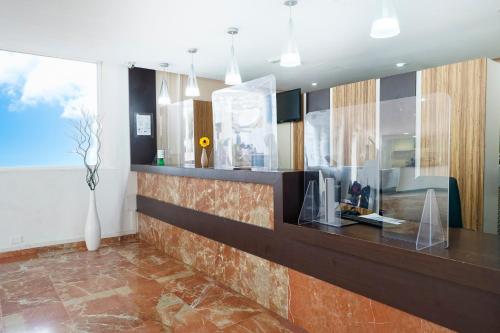 a lobby with a counter with a vase on it at LABRANDA Bahía Fañabé & Villas in Adeje