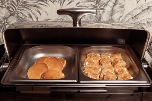 two trays of food with biscuits and buns at Aeolos Boutique Hotel & Suites in Kalamaki