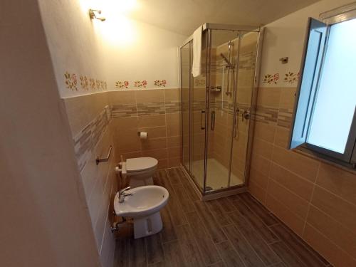 a bathroom with a shower and a toilet and a sink at Locanda Prato d'Era in Volterra