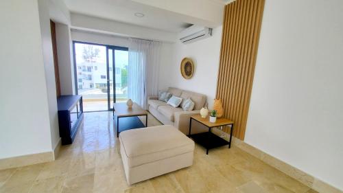 a living room with a couch and a table at Amar'e Aparthotel & Spa in Las Terrenas