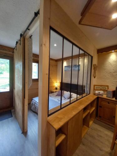 a room with a mirror and a bed in it at Chalet Campanule in Bonneval-sur-Arc