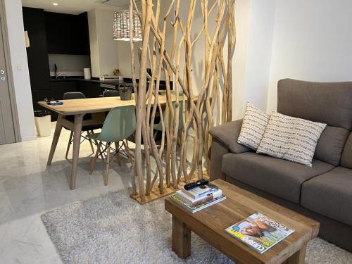 a living room with a couch and a table at Moraira Fantástico Ático Duplex in Moraira