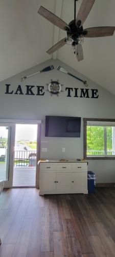 a large living room with a table and a ceiling fan at Grand View Resort in Weirs Beach