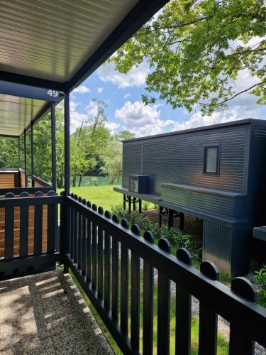 une petite maison sur une terrasse avec un banc dans l'établissement Micro-Cabin by the Kolpa River Metlika, à Gradac