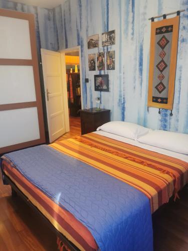 a bedroom with two beds and a door at B&B La Casa del Barbiere in Modena