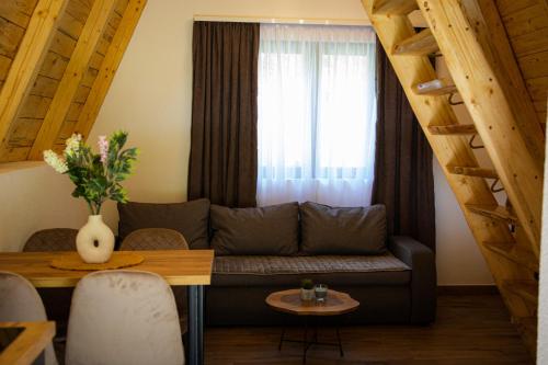 a living room with a couch and a window at Natures Escape Kozarica in Šavnik