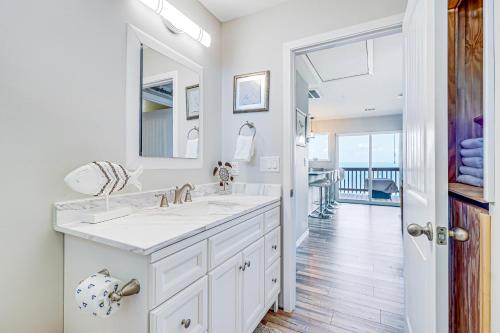 a white bathroom with a sink and a mirror at The Ridge in Rockport
