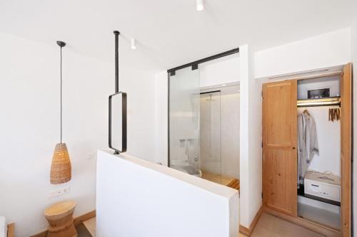 a room with white walls and a sliding glass door at Kalkan Han Hotel in Kalkan