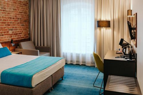 Ein Bett oder Betten in einem Zimmer der Unterkunft Arche Hotel Tobaco Łódź