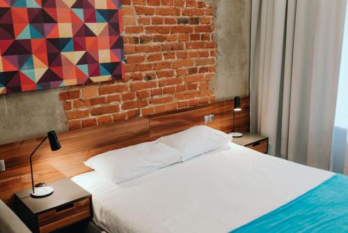 Ein Bett oder Betten in einem Zimmer der Unterkunft Arche Hotel Tobaco Łódź