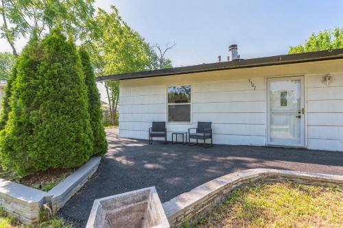 a house with two chairs in front of it at Charming Contemporary Family Home home in Glenview