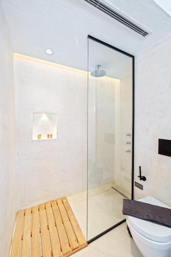 a glass shower in a bathroom with a toilet at Kalkan Han Hotel in Kalkan