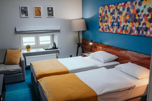 Ein Bett oder Betten in einem Zimmer der Unterkunft Arche Hotel Tobaco Łódź