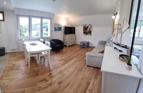 a living room with a table and a couch at Gites de charme centre de 2 à 8P, jardin, parking, durable in Honfleur