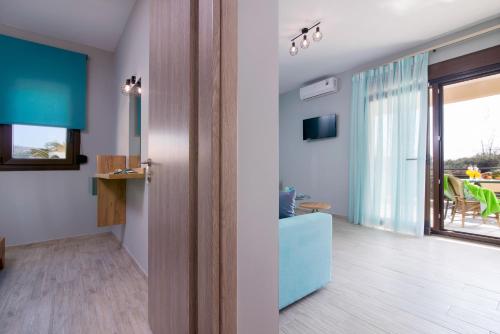 a living room with a view of a dining room at Homelia in Limenaria