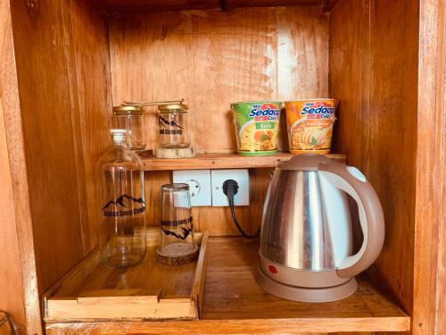 a small kitchen with a blender and other items at Buahan Sweet Glamping ( BSG) in Kubupenlokan