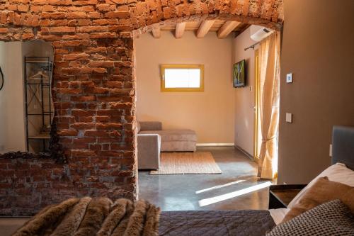 a living room with a brick wall and a couch at Bed & Breakfast Gioia di... in Santo Stino di Livenza