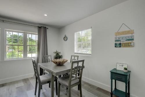 a dining room with a table and chairs at Walk to Downtown Bonita Springs From Our Home in Bonita Springs