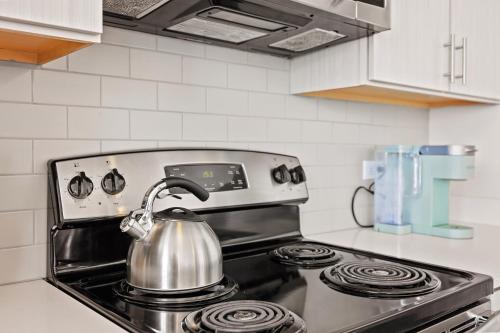 a tea kettle on top of a stove in a kitchen at Placemakr Premier SoBro in Nashville