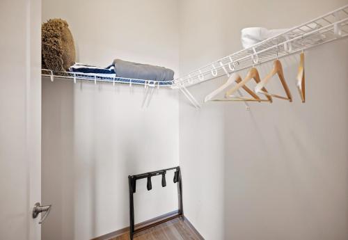 a walk in closet with a shelf and shoes at Placemakr Premier SoBro in Nashville