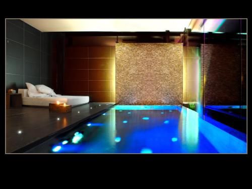 a swimming pool with a candle in a room at Boutique hotel Urbisol in Calders