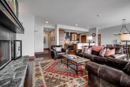a living room with a couch and a fireplace at Luxury 3 BR Residence-Ski-in out in Bachelor Gulch condo in Avon