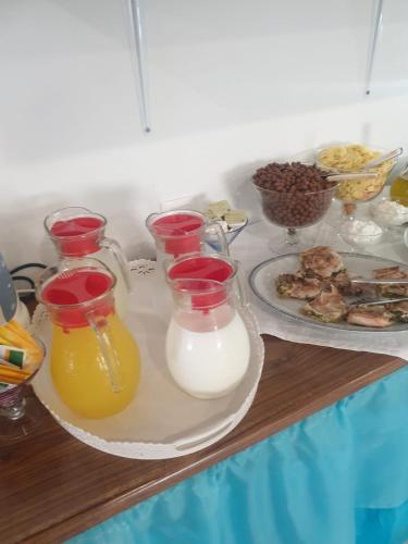 una tavola con bottiglie di latte e un piatto di cibo di Riviera Seaside Hotel by Estia a Benitses