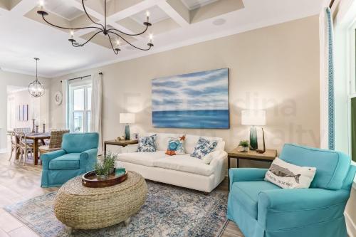 a living room with blue chairs and a couch at 2206 Shell Cove Circle home in Fernandina Beach