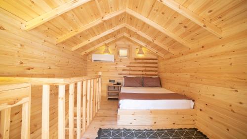 a room with a bed in a wooden cabin at My Home Hotel Gulluk in Antalya