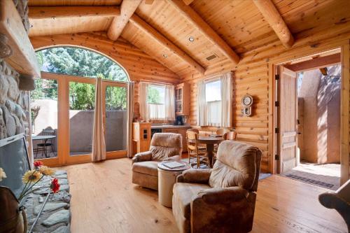a log cabin living room with a table and chairs at Adobe Village Villa with Private Patio- Wilderness villa in Sedona