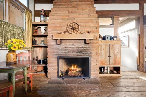 a living room with a brick fireplace with a clock at Adobe Village Inn in Sedona