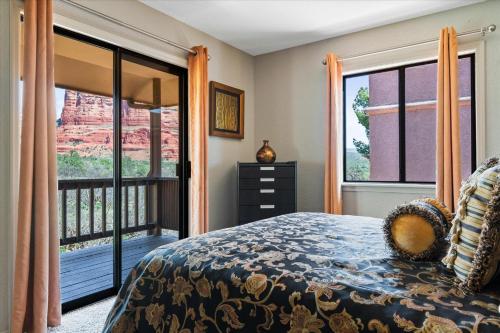 a bedroom with a bed and a balcony at 100 Bell RockCondo- ToroWeap condo in Sedona