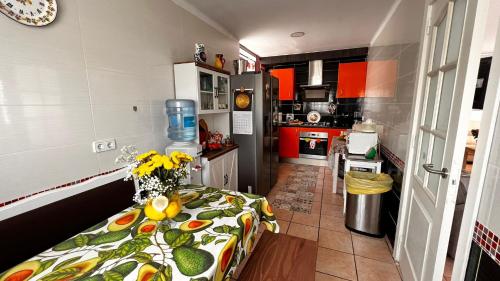 a kitchen with a table with a vase of flowers on it at Ideal Property Mallorca - Es Romani Alcudia in Alcudia