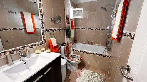 a bathroom with a sink and a toilet and a tub at Ideal Property Mallorca - Es Romani Alcudia in Alcudia