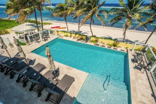 an overhead view of a swimming pool and the beach at Fischers Reef by Grand Cayman Villas & Condos in Driftwood Village
