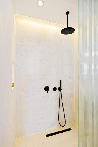 a bathroom with a wall with a shower with a face drawn on it at Kalkan Han Hotel in Kalkan