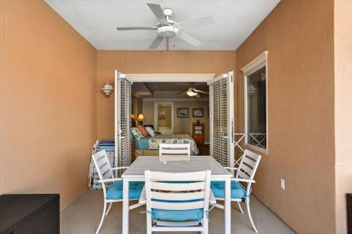 a dining room with a table and chairs and a ceiling fan at Unique 3BR, 1 of 5 Condos w/Huge Poolside Patio, Steps to Beach & Pier, Gated in Tybee Island