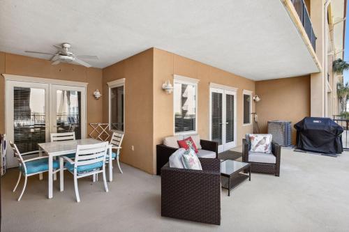a living room with a table and chairs at Unique 3BR, 1 of 5 Condos w/Huge Poolside Patio, Steps to Beach & Pier, Gated in Tybee Island