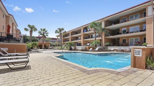 a swimming pool in front of a apartment building at Unique 3BR, 1 of 5 Condos w/Huge Poolside Patio, Steps to Beach & Pier, Gated in Tybee Island