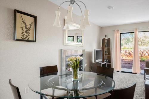a dining room with a glass table and chairs at 100 Bell Rock Condo- Supai condo in Sedona