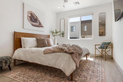 a bedroom with a large bed and a window at Lagoon Vibes townhouse in St. George