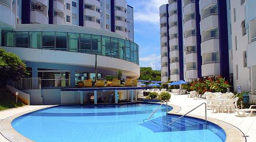 a large building with a swimming pool in front of it at IMG Hotel Rio Quente in Rio Quente