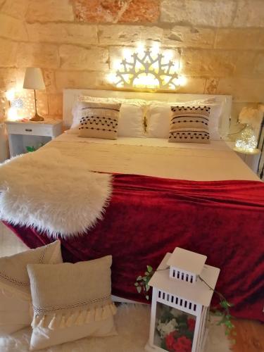 a bedroom with a large bed with red and white pillows at Palazzo Emy in Lecce