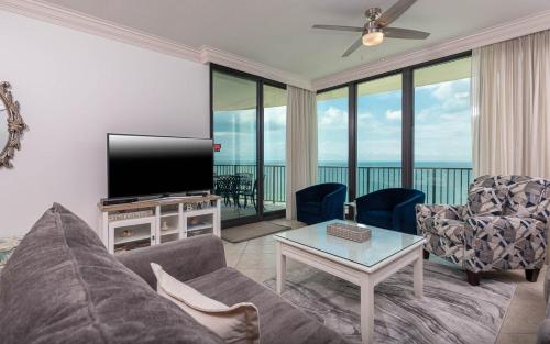 a living room with a couch and a flat screen tv at Phoenix IX 1105 condo in Orange Beach