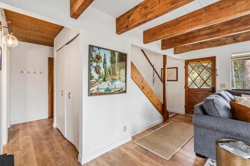 a living room with white walls and wooden beams at Marina Beach Cabin - Dog-Friendly Home with Deck! home in Groveland