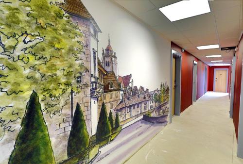 a hallway with a wall mural of a castle at Sure Hotel by Best Western Dole in Dole