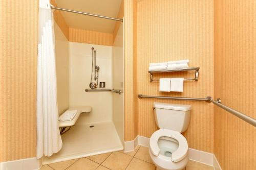 a bathroom with a toilet and a shower at HOLIDAY INN EXPRESS & SUITES ELK GROVE CENTRAL - HWY 99 by IHG in Elk Grove