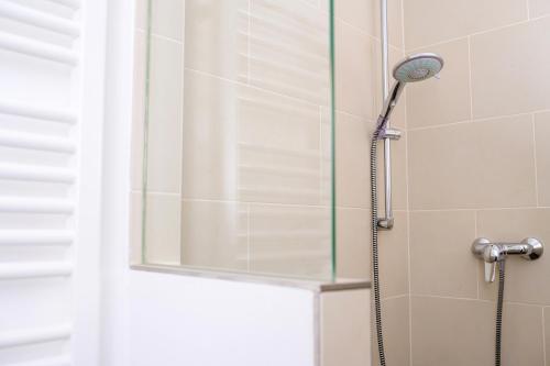 a shower with a shower head in a bathroom at Pension Kleine Residenz in Weimar