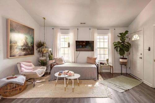 a bedroom with a bed and a couch and a table at RARE Downtown Matthews walk 2 shops restauraunts hike CLT 2 Bedroom not 3br in Charlotte