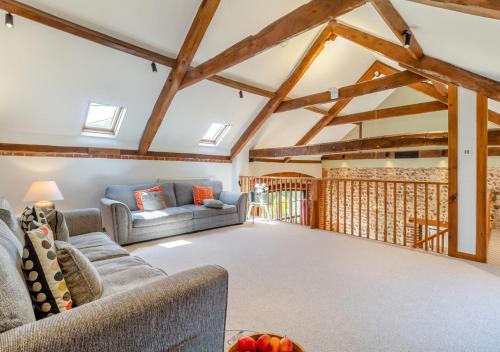 a living room with two couches and a table at The Little Barn in Felbrigg